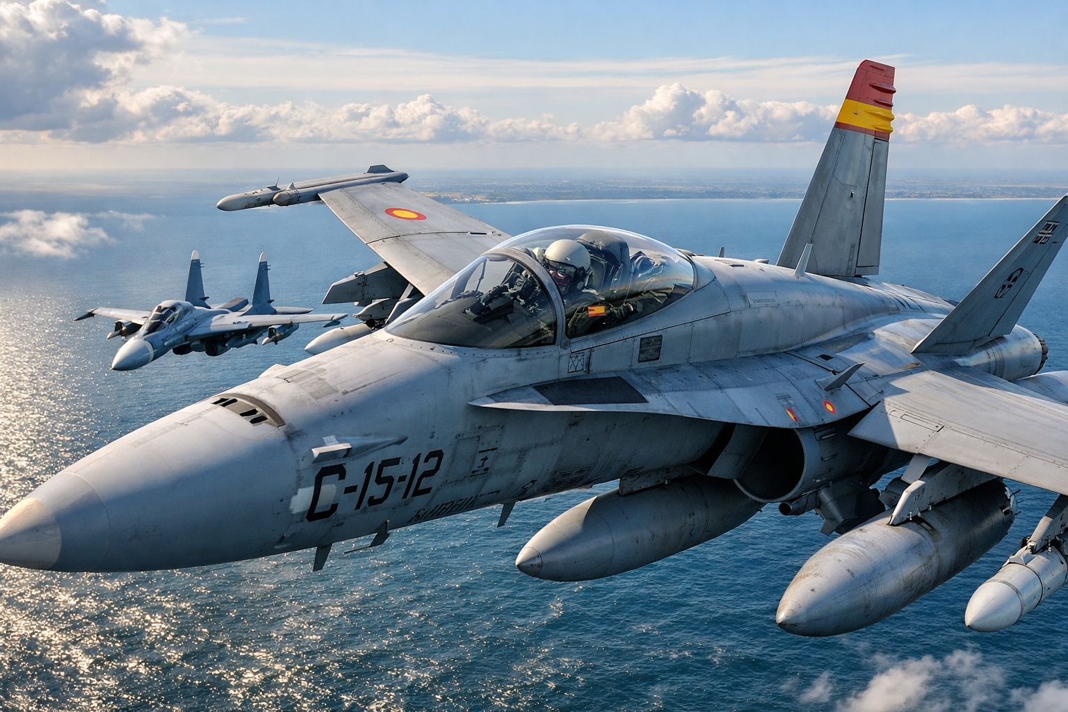 Dois aviões militares a jato a voar sobre o mar em céu parcialmente nublado.