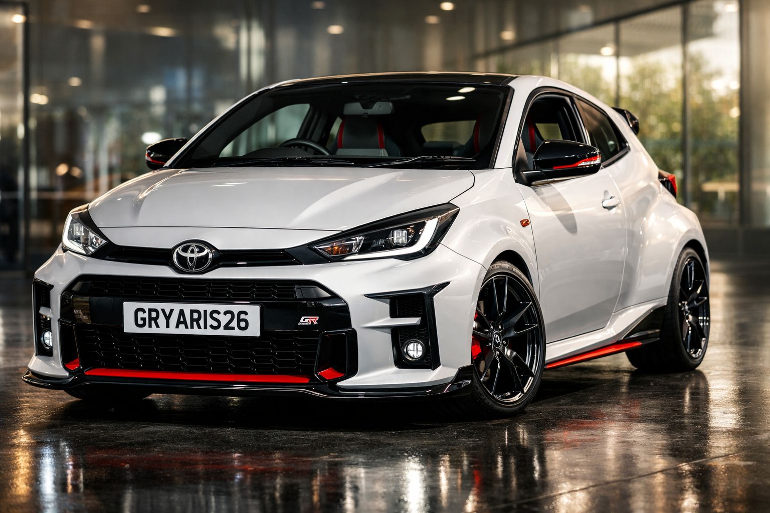Carro desportivo branco Toyota GR Yaris estacionado em interior com detalhes vermelhos e jantes pretas.