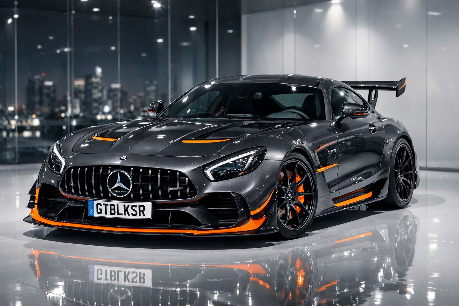 Mercedes-Benz desportivo cinzento com detalhes laranja, faróis LED e spoiler traseiro, em ambiente interior moderno.